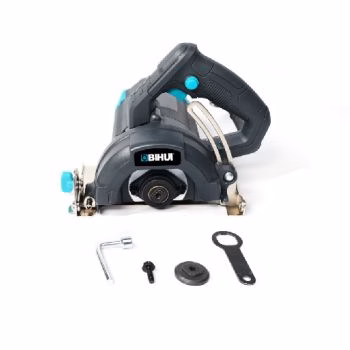 Electric Stone Cutter, blade, and installation tools sitting on a white surface. 
